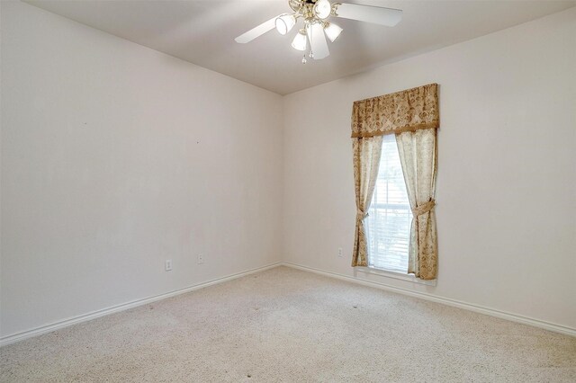 empty room with light colored carpet and ceiling fan