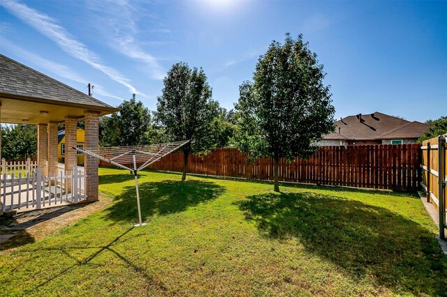 view of yard featuring a patio and a storage unit