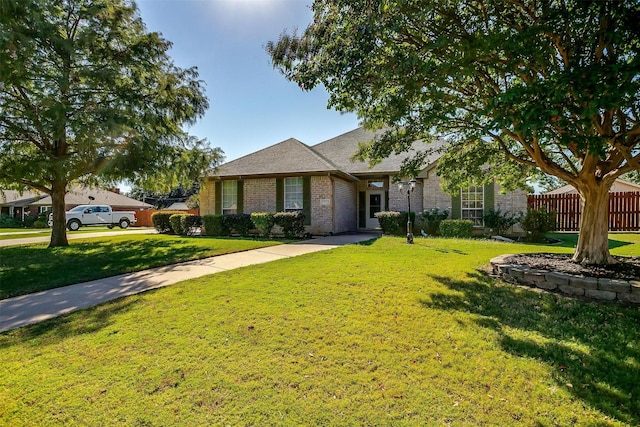 single story home featuring a front lawn