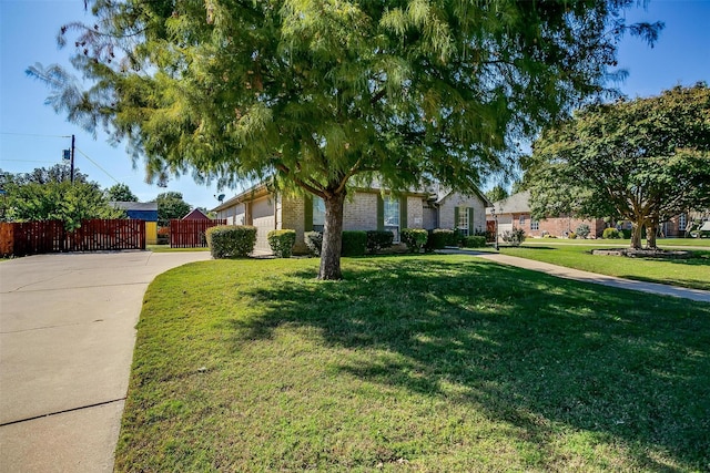 single story home featuring a garage and a front lawn