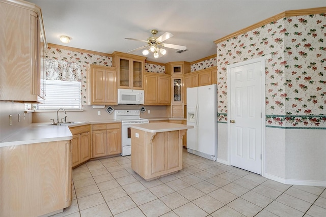 kitchen featuring sink, white appliances, a center island, ornamental molding, and ceiling fan