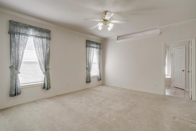 carpeted bedroom featuring connected bathroom, ceiling fan, and crown molding