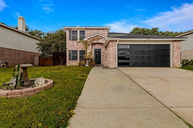 view of property featuring a garage and a front lawn