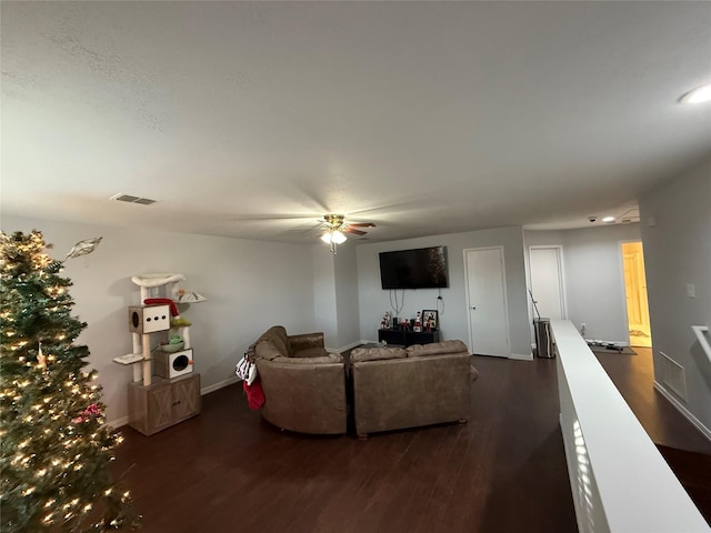 living room with dark hardwood / wood-style floors and ceiling fan