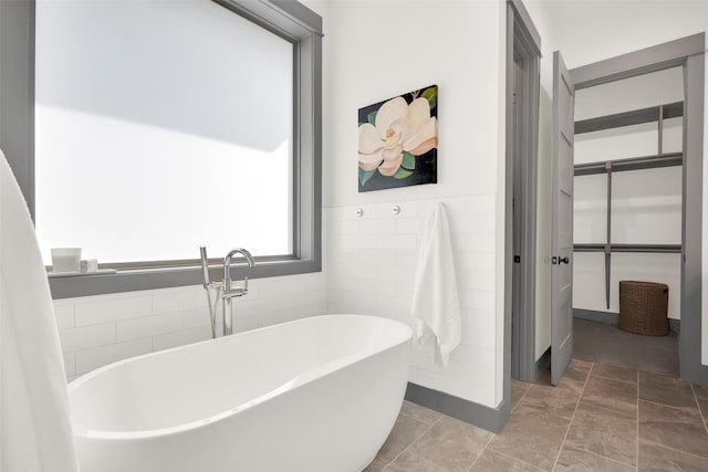 bathroom featuring a tub to relax in