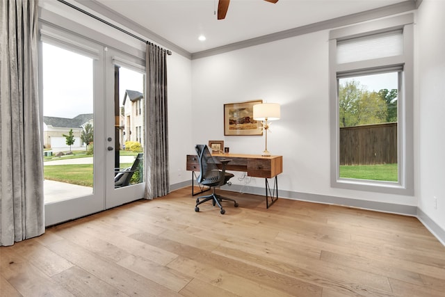 home office with light hardwood / wood-style floors, crown molding, french doors, and ceiling fan