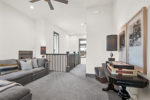 living room featuring ceiling fan and carpet