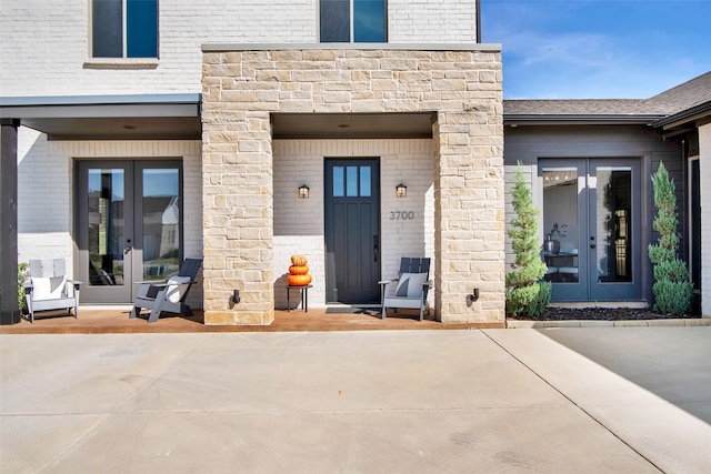 property entrance with a patio and french doors