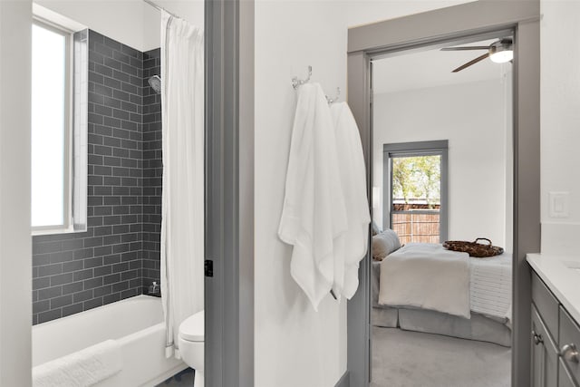 full bathroom featuring vanity, toilet, shower / bath combination with curtain, and ceiling fan