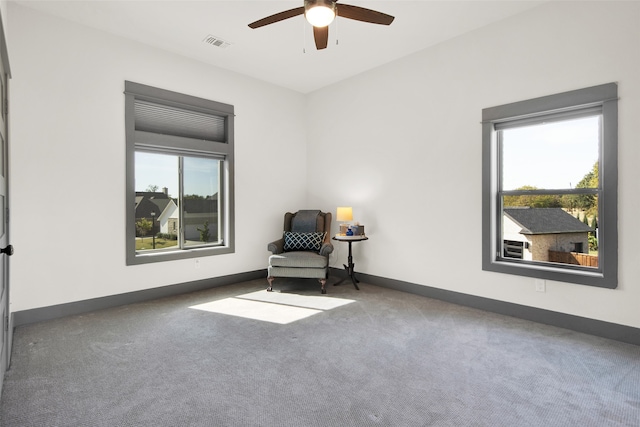 unfurnished room with dark carpet, a healthy amount of sunlight, and ceiling fan