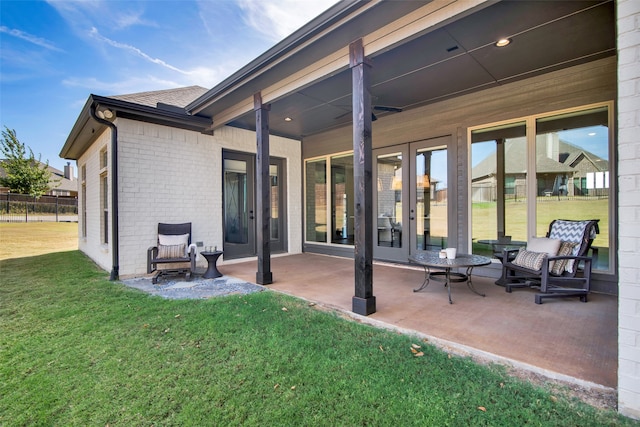 rear view of property featuring a patio and a lawn