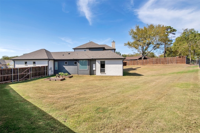 back of house with a yard