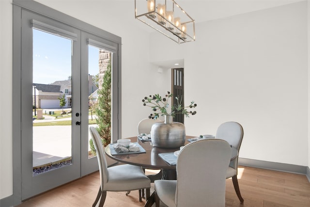 dining area featuring french doors and light hardwood / wood-style flooring