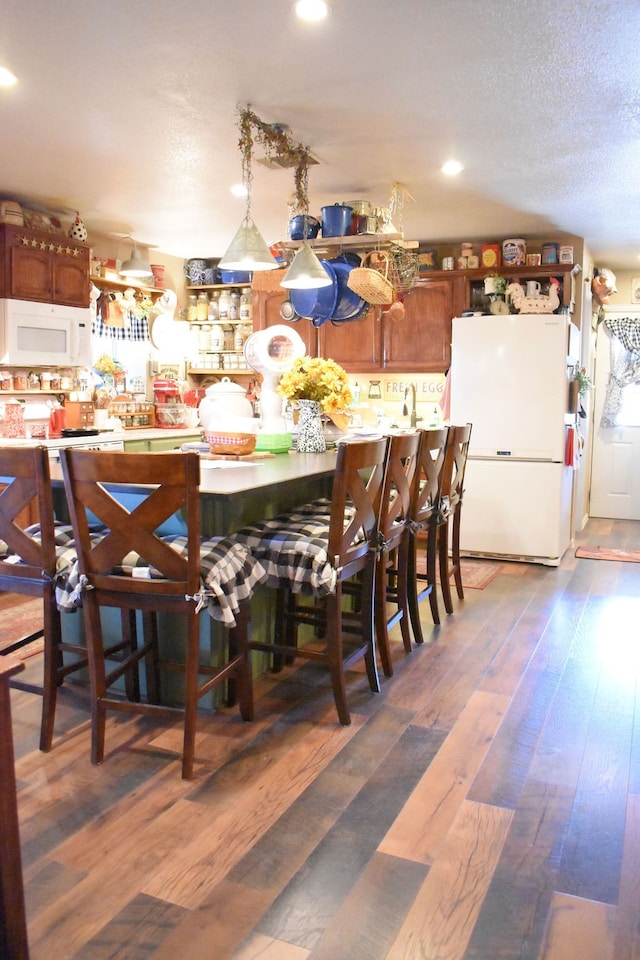 dining space featuring dark wood-type flooring