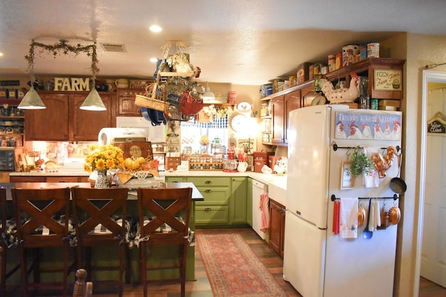 kitchen featuring hanging light fixtures and white appliances