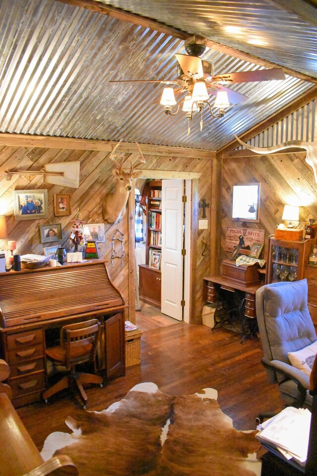 office featuring wooden walls, wood-type flooring, vaulted ceiling, and ceiling fan