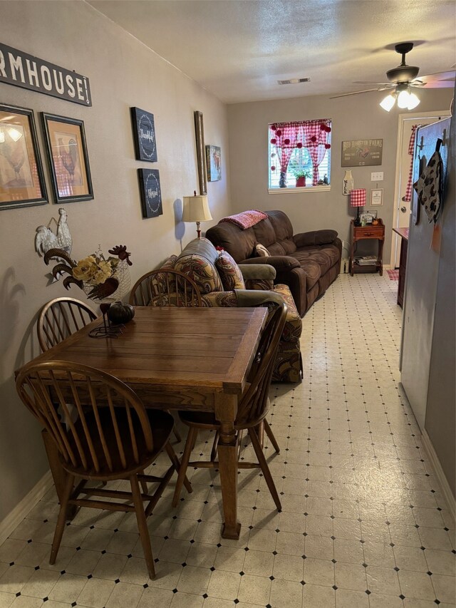 dining area featuring a textured ceiling and ceiling fan