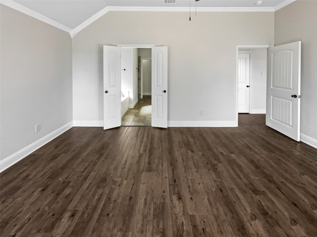 unfurnished bedroom with ornamental molding, dark wood-type flooring, and vaulted ceiling