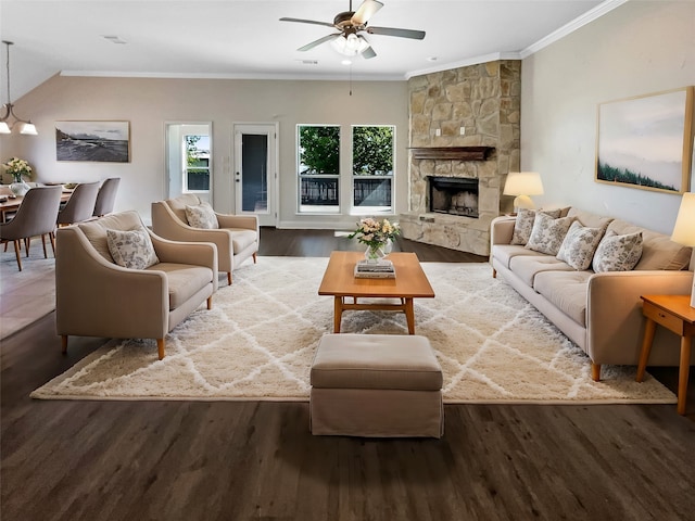 living room featuring a fireplace, ceiling fan, vaulted ceiling, hardwood / wood-style flooring, and ornamental molding