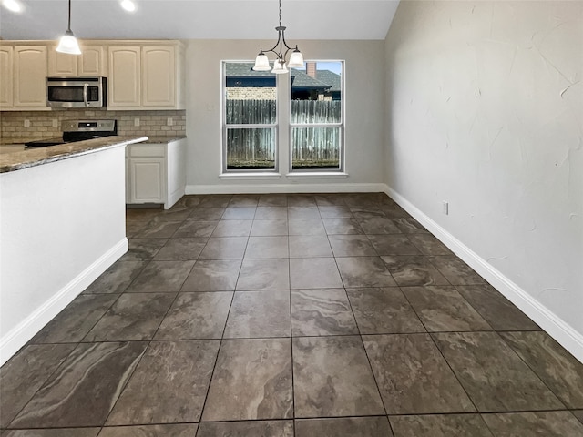 kitchen with lofted ceiling, decorative backsplash, appliances with stainless steel finishes, a chandelier, and decorative light fixtures