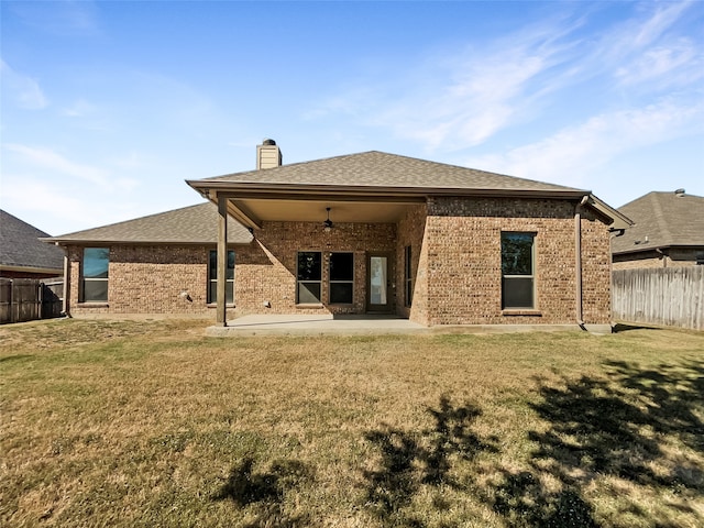 rear view of property with a patio area, a lawn, and ceiling fan