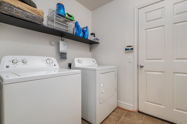 washroom featuring washer and clothes dryer and light tile patterned floors