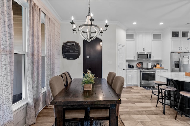 dining space with crown molding and a notable chandelier