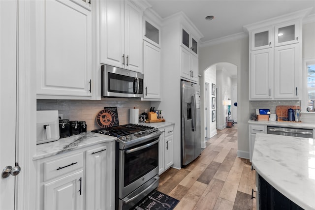 kitchen featuring appliances with stainless steel finishes, light hardwood / wood-style flooring, and white cabinetry