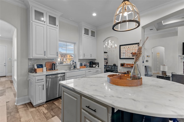 kitchen featuring white cabinetry, a notable chandelier, stainless steel dishwasher, and a kitchen island