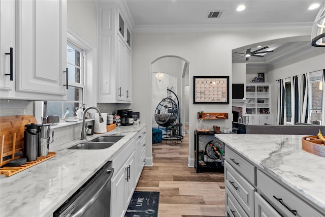 kitchen with white cabinets, ceiling fan, dishwasher, crown molding, and sink