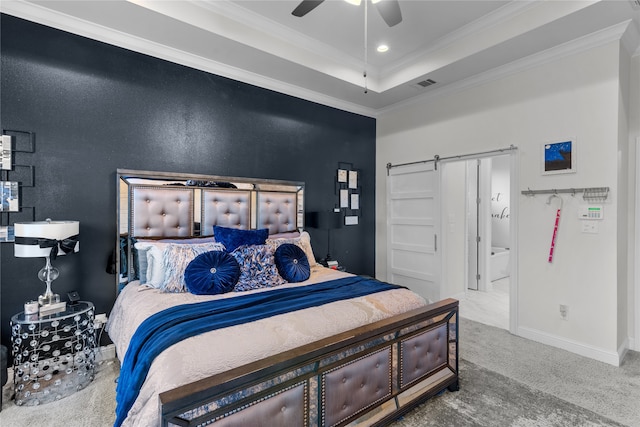 bedroom with connected bathroom, ornamental molding, a barn door, carpet flooring, and ceiling fan