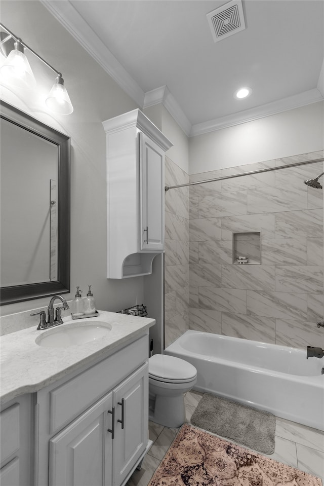 full bathroom featuring vanity, tiled shower / bath combo, ornamental molding, and toilet