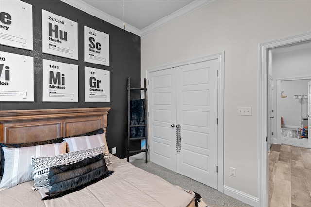 bedroom with crown molding and hardwood / wood-style floors