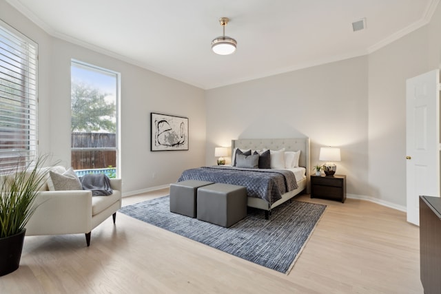 bedroom with light hardwood / wood-style floors and ornamental molding