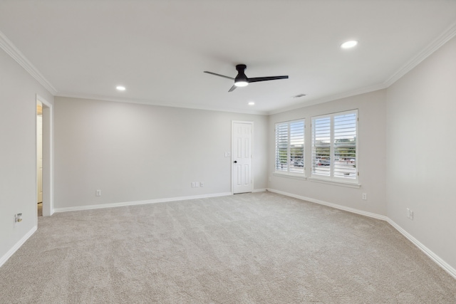 empty room featuring light carpet, ornamental molding, and ceiling fan