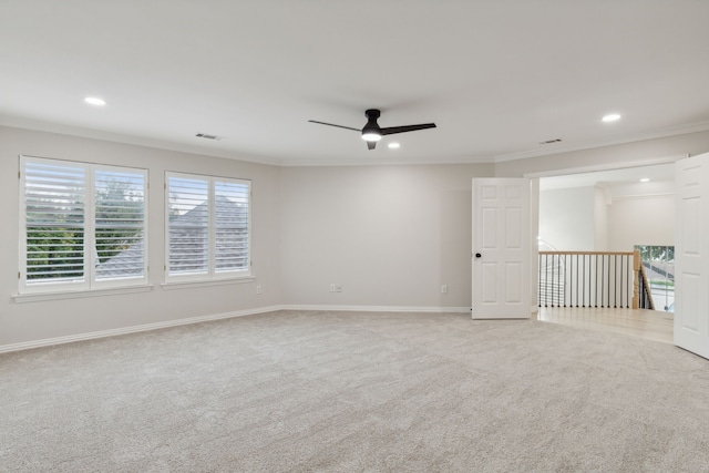 carpeted spare room with crown molding and ceiling fan