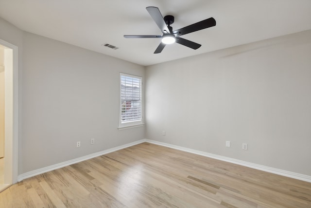 spare room with light wood-type flooring and ceiling fan