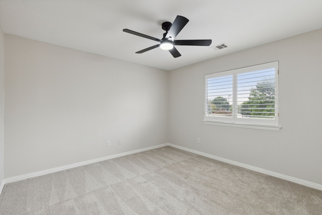 spare room featuring ceiling fan and light colored carpet