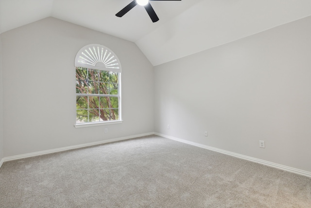 spare room with ceiling fan, carpet flooring, and vaulted ceiling