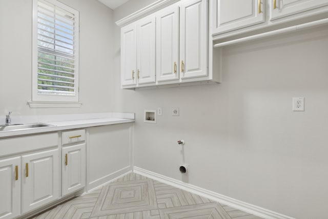 washroom with cabinets, washer hookup, electric dryer hookup, hookup for a gas dryer, and sink