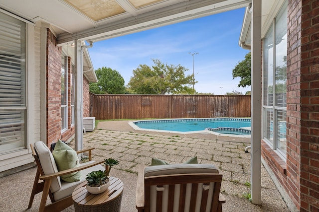 view of pool with a patio and an in ground hot tub