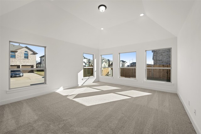 interior space with light carpet and high vaulted ceiling