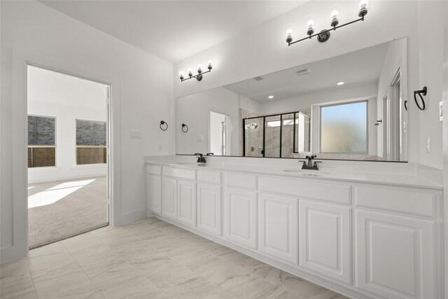 bathroom featuring vanity and a shower with shower door