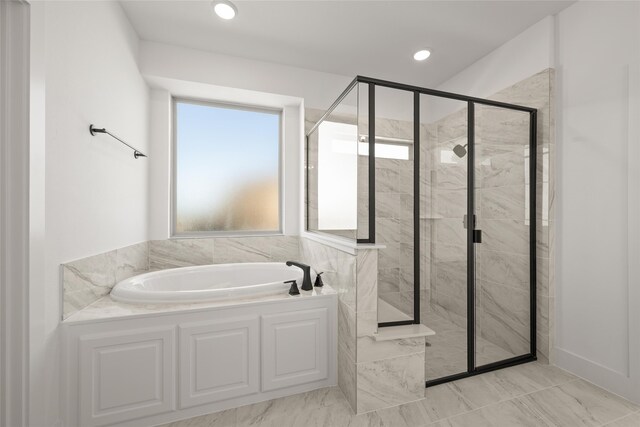 bathroom featuring independent shower and bath