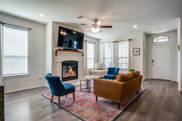 living room featuring hardwood / wood-style floors and ceiling fan