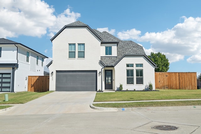 view of front of home with a front yard and a garage