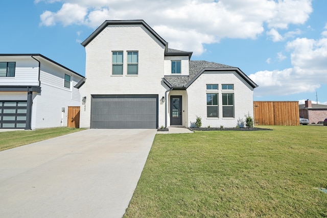 view of front of house featuring a front yard and a garage