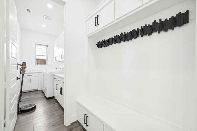 mudroom featuring dark hardwood / wood-style flooring and washing machine and clothes dryer