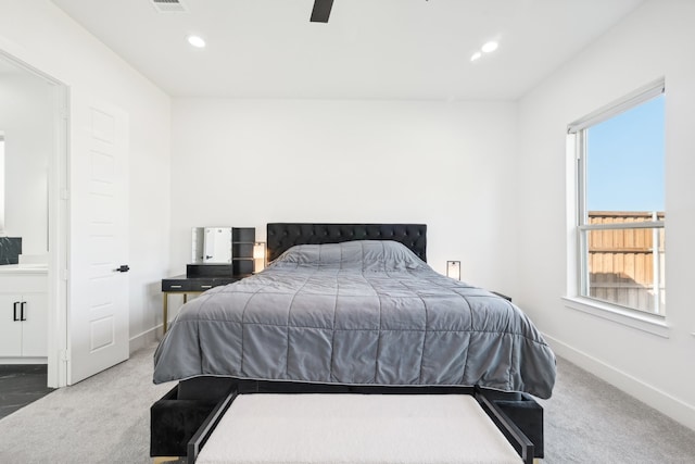 carpeted bedroom featuring multiple windows and ceiling fan