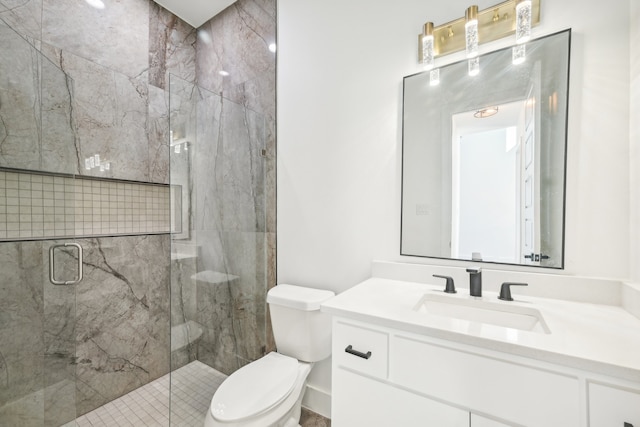 bathroom featuring vanity, toilet, and a shower with shower door